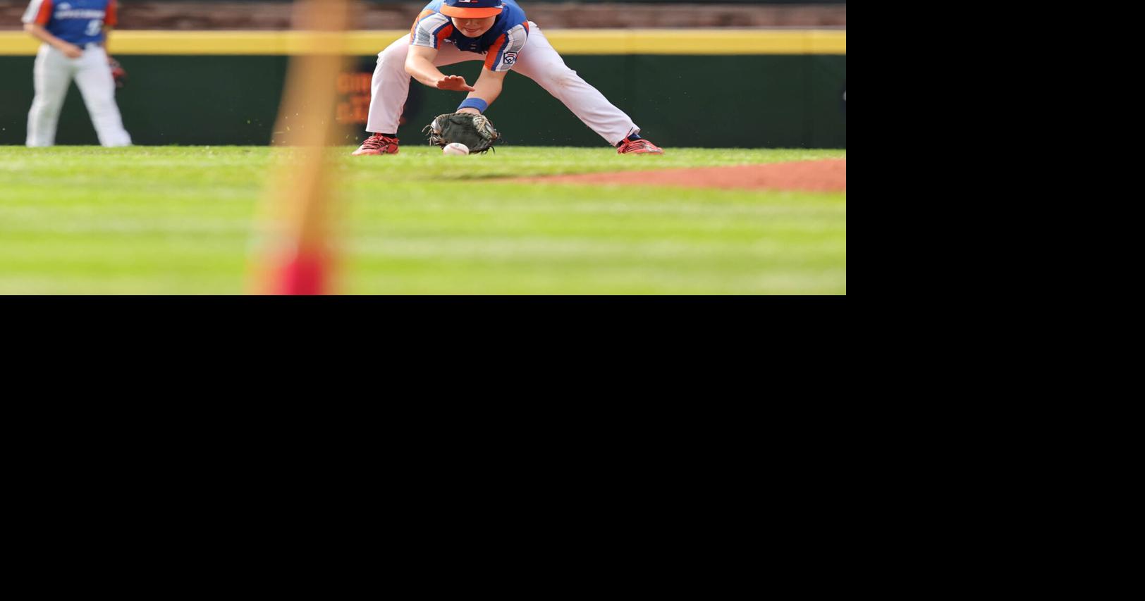 Shortstop Leo Feltner of Hamilton, Ohio, (Great Lakes Region) fields the ground ball and throws out the runner at first base
