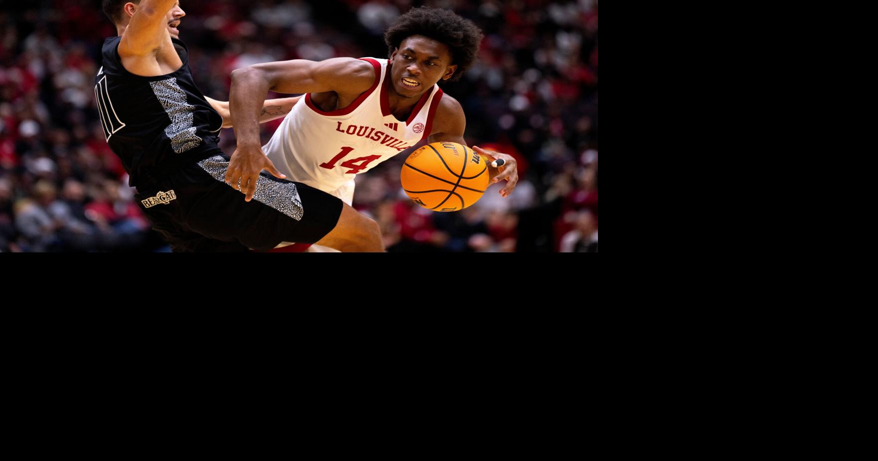 Cincinnati Bearcats guard Kerr Kriisa (11) fouls Louisville Cardinals guard Adrian Wooley (14) in the first half of the NCAA