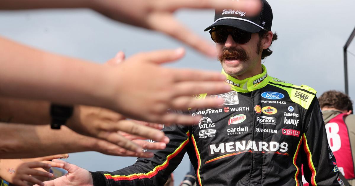 Jul 5, 2026; Joliet, Illinois, USA; NASCAR Cup Series driver Ryan Blaney (12) shakes hands with fans before the eero 400 at Chicagoland Speedway. Mandatory Credit: Mike Dinovo-Imagn Images