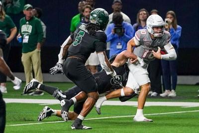 Dec 23, 2025; Frisco, TX, USA;  Ohio Bobcats linebacker Charlie Christopher (30) makes the tackle of UNLV Rebels quarterback Anthony Colandrea (10) during the second half at the Ford Center at The Star. Mandatory Credit: Raymond Carlin III-Imagn Images