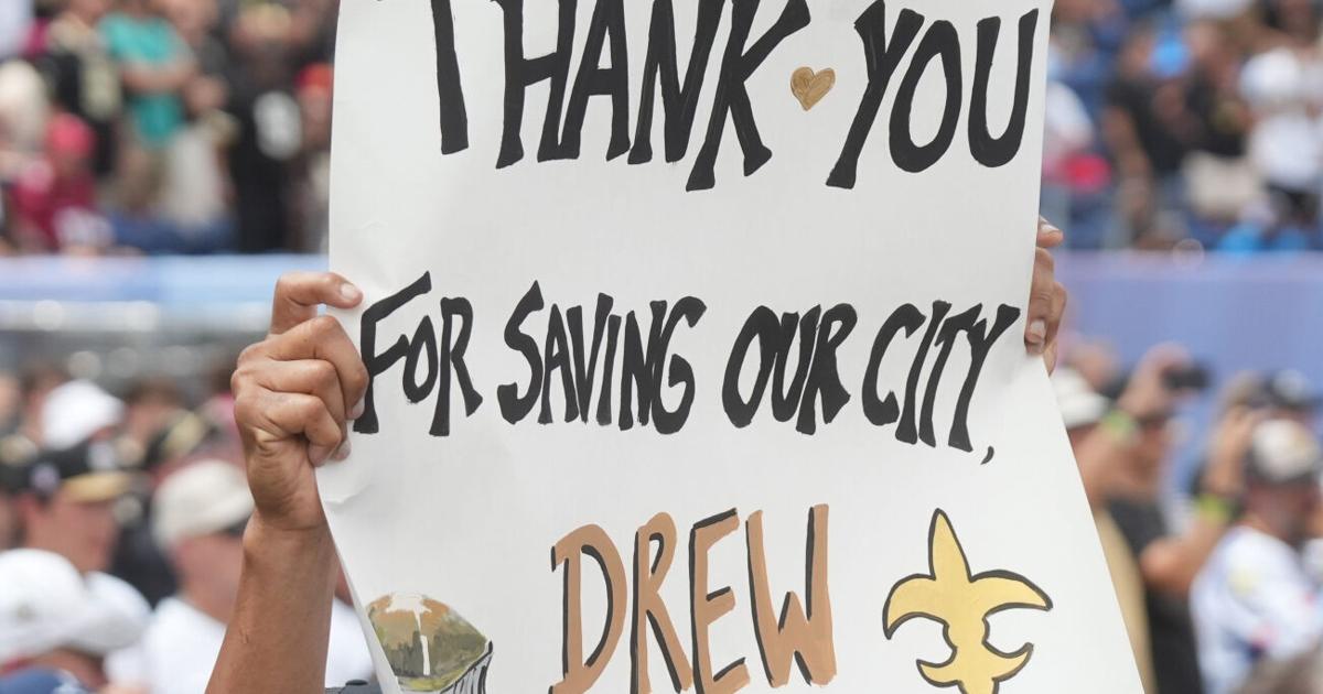 A fan holds up a sign for Drew Brees at the Pro Football Hall of Fame induction ceremony at the Pro Football Hall of Fame ,