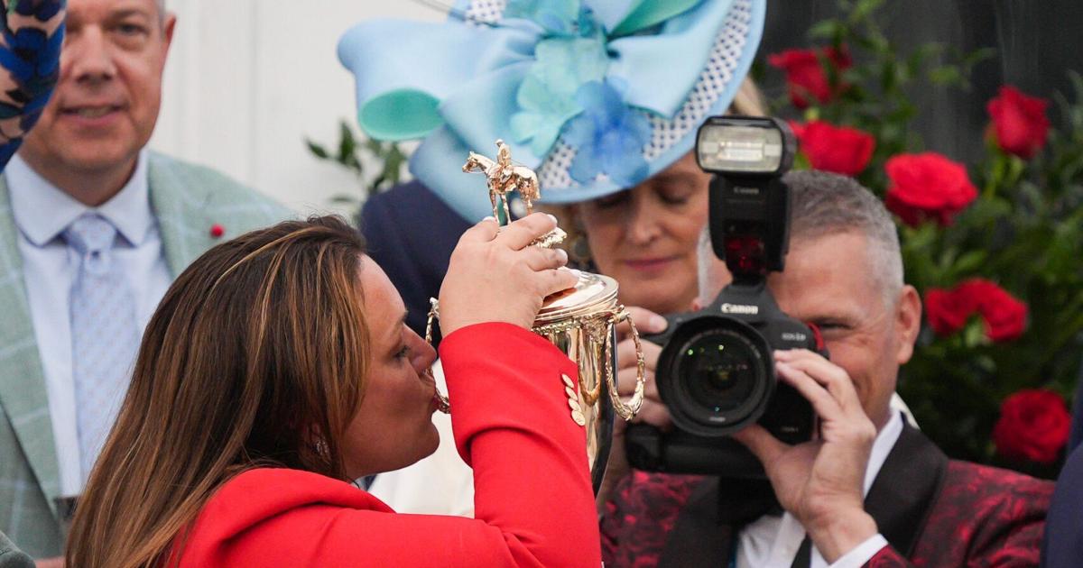 Trainer Cherie DeVaux kisses the trophy after her horse Golden Tempo with Jose L. Ortiz won the 2026 Kentucky Derby at Churchill