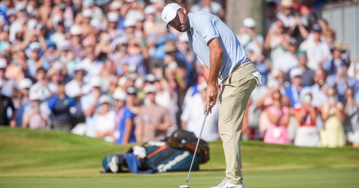 Scottie Scheffler putts on the 18th hole to win the FedEx St. Jude Championship with an eight stroke lead at TPC Southwind in