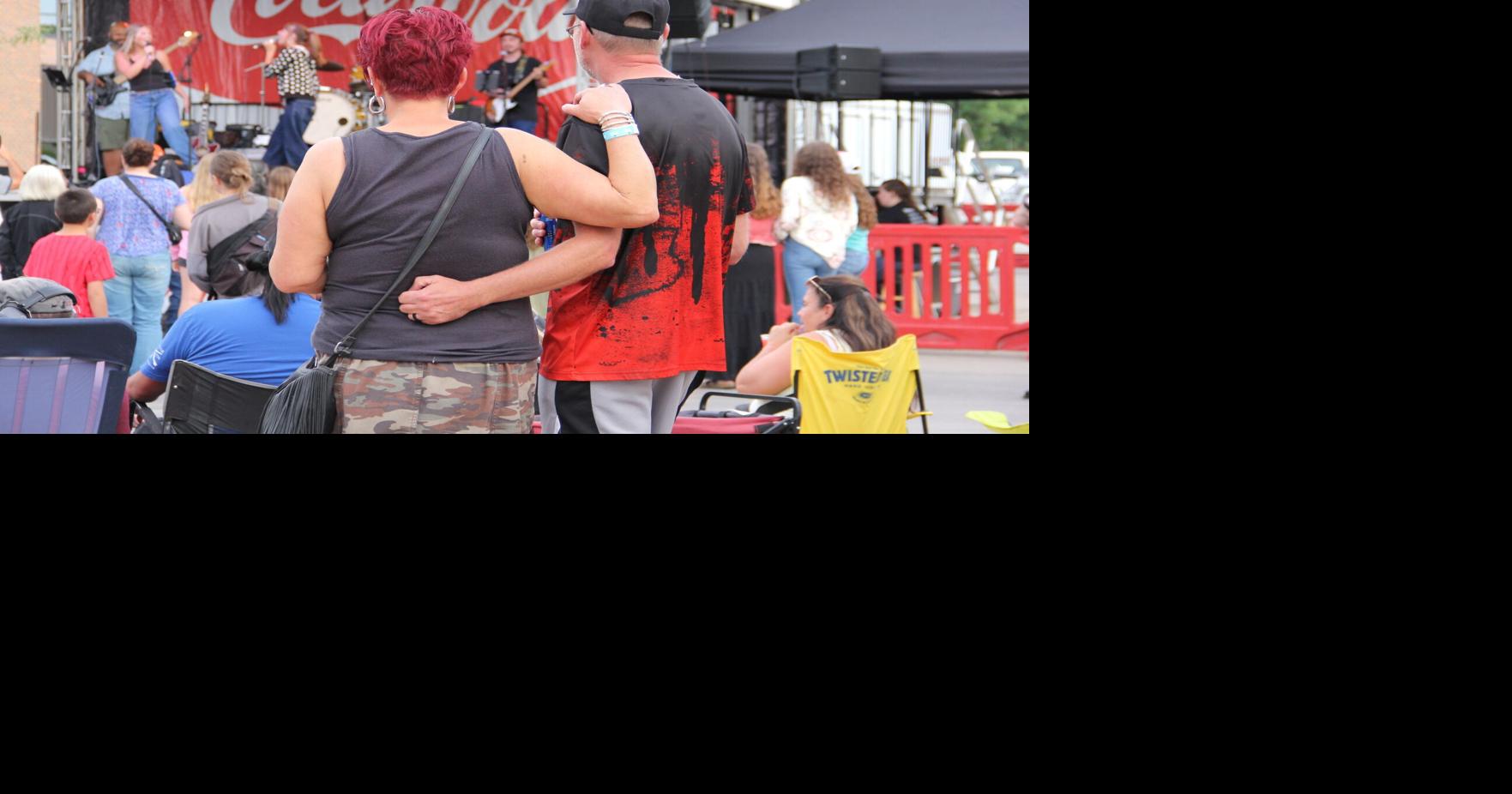 Couple wraps arms around one another