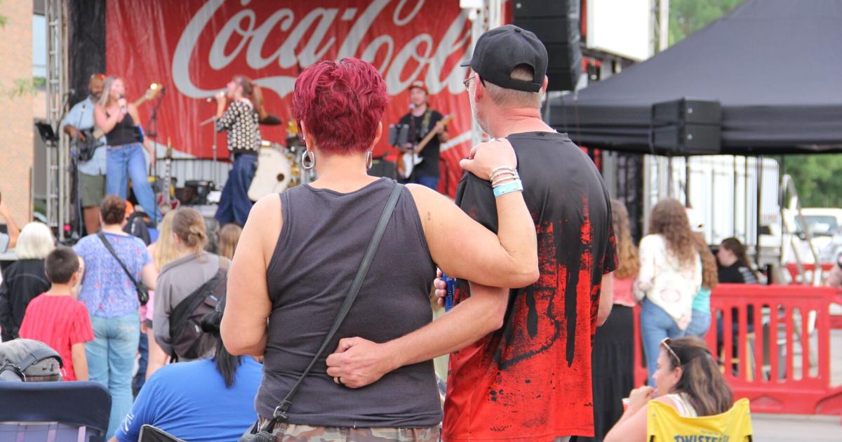 Couple wraps arms around one another