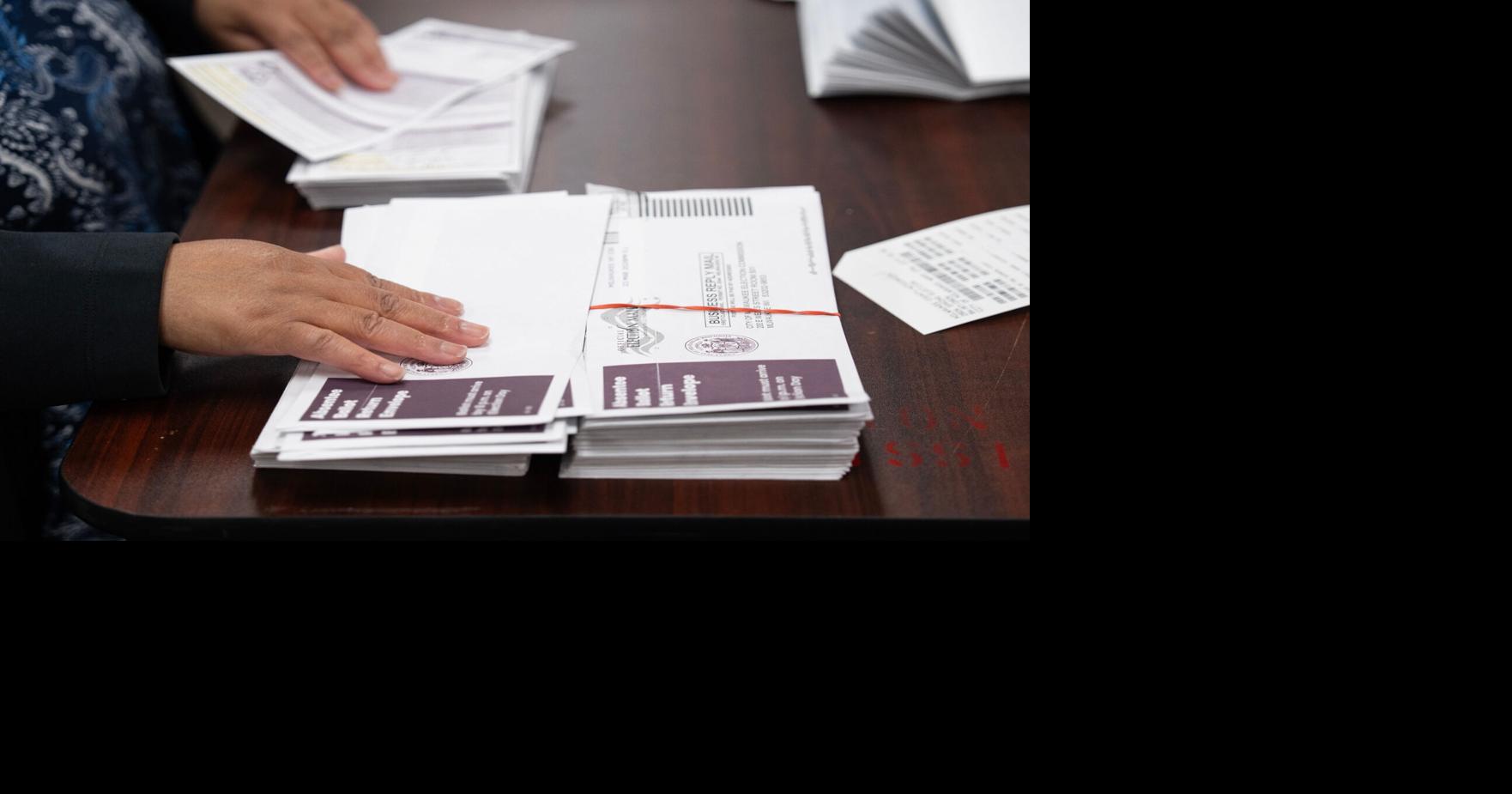 Jackie Jones works with Jon Bruning to process absentee ballots, verifying the address with the original request, at Central Count on Election Day, April 7, 2026 in Milwaukee, Wisconsin.