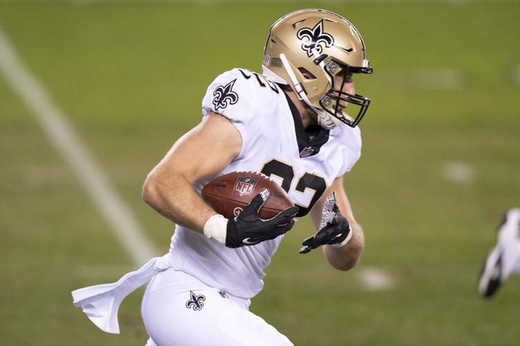 New Orleans Saints tight end Adam Trautman (82) runs the ball up