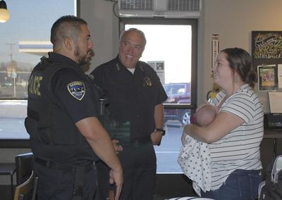 StarbucksLeft: Officer Eric Campa and Chief Matt Hamner chat with Lacy Guzman and 2-month-old Gael Guzman