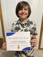 A fifth grader's fundraiser cleared his school of meal debt. It named an award for him