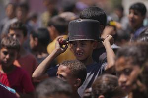 Hungry Palestinians in Gaza block and offload dozens of UN food trucks