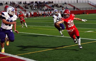Madison's Barkley Beck extends the ball on his way to the endzone.