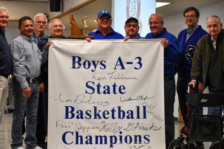 Team posing with championship banner