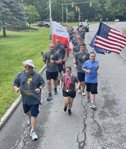 Special Olympics athletes run the torch in Utica with Sheriff's Office ...