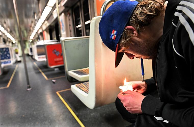 Matthew Morales smokes fentanyl on the Red Line in the Metro subway leaving MacArthur Park on Feb. 28, 2023.
