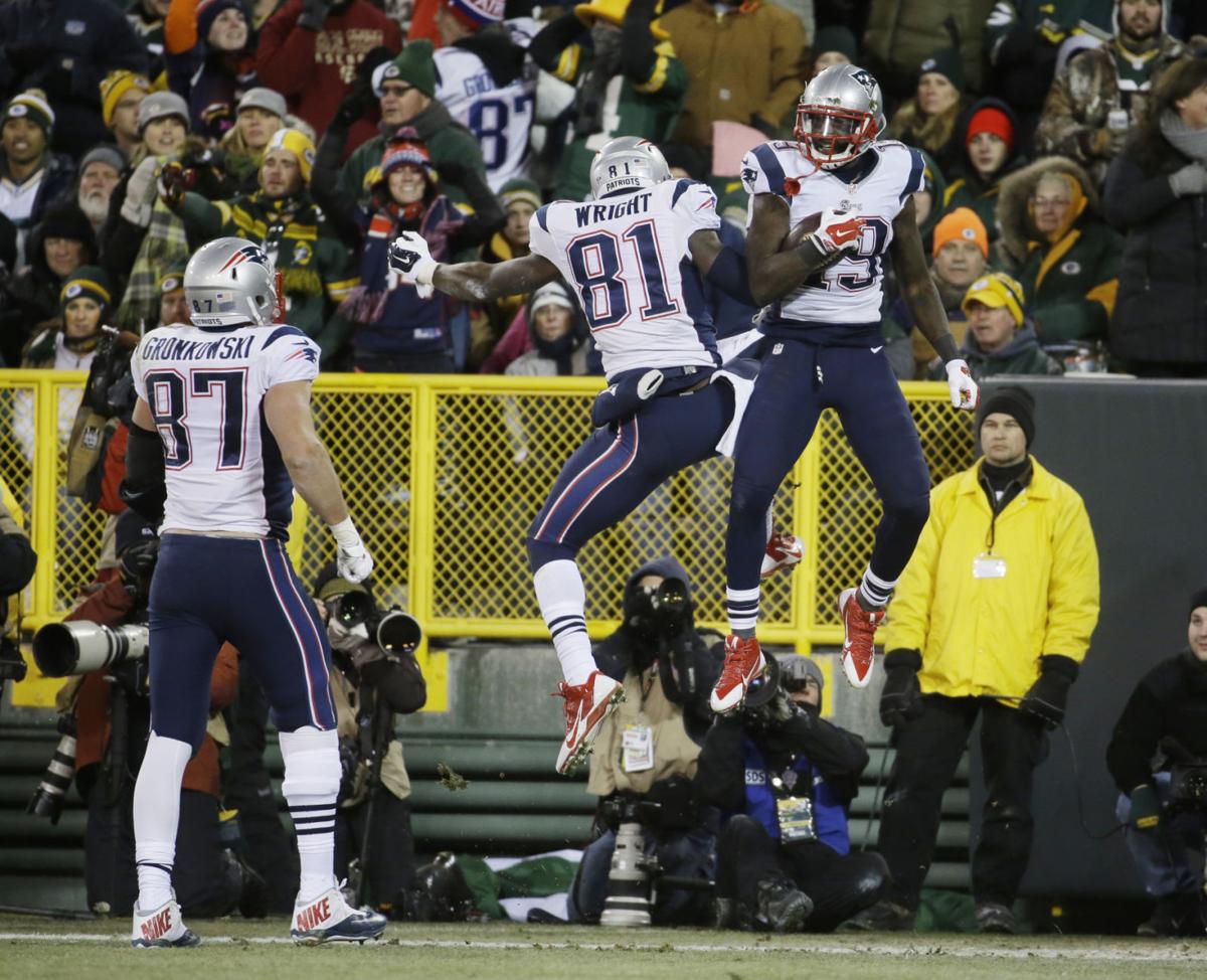 New England Patriots' Rob Gronkowski (87) watches as Brandon LaFell (19) celebrates his touchdown catch with Timothy Wright (81) during the second half.