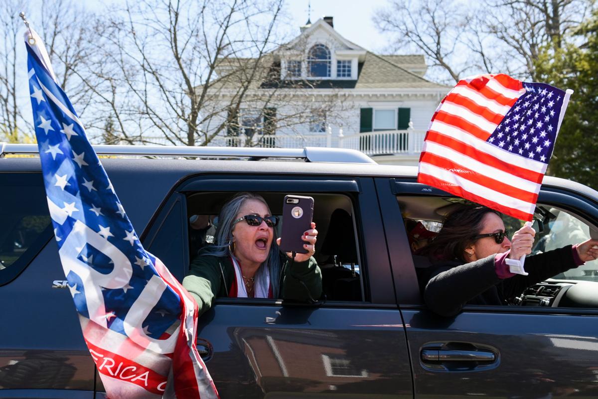 Protesters gather outside Gov. Charlie Baker's home in Swampscott