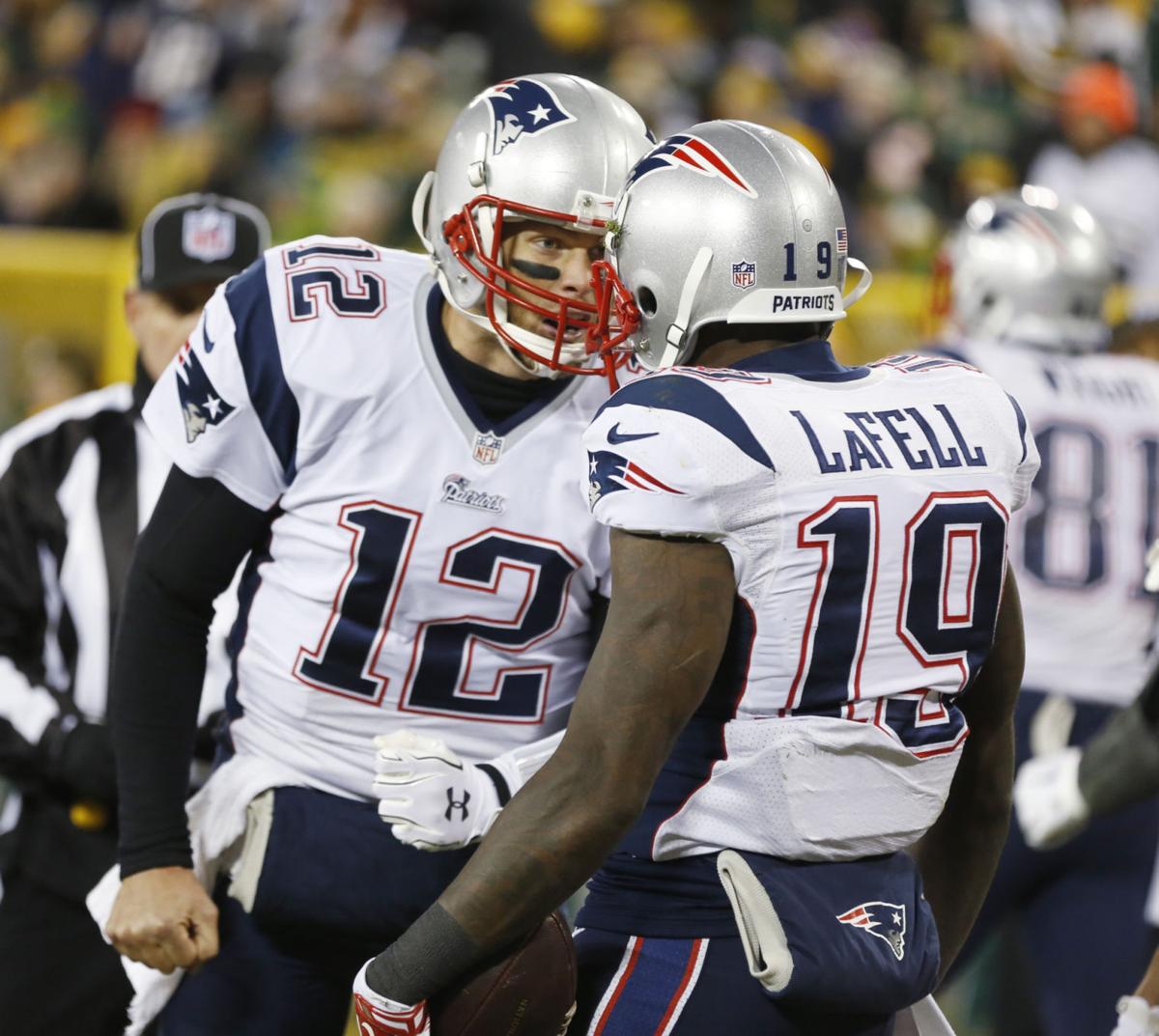 New England Patriots' Tom Brady (12) celebrates Brandon LaFell's touchdown catch during the second half.