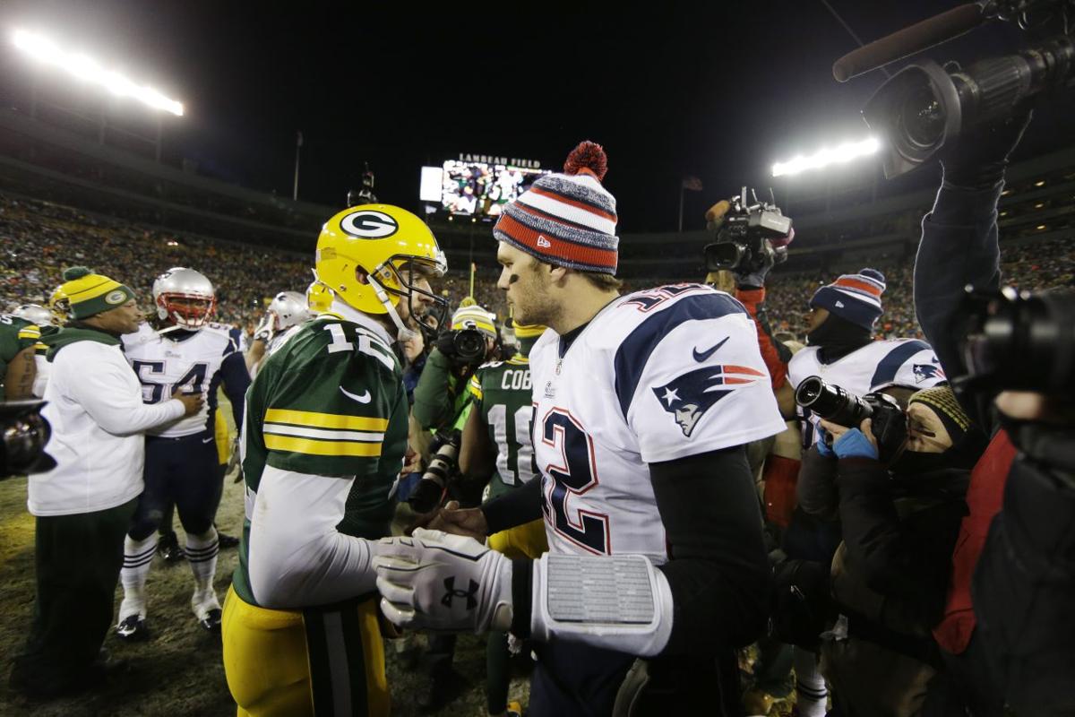 Green Bay Packers' Aaron Rodgers shakes hands with New England Patriots' Tom Brady after the game.
