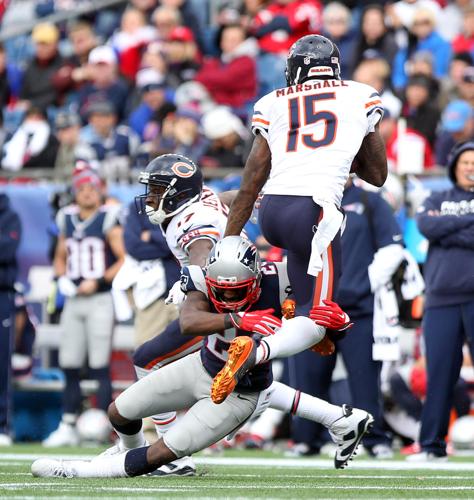 Chicago Bears wide receiver Brandon Marshall (15) tries to leap over New  England Patriots cornerback Darrell Revis (24)