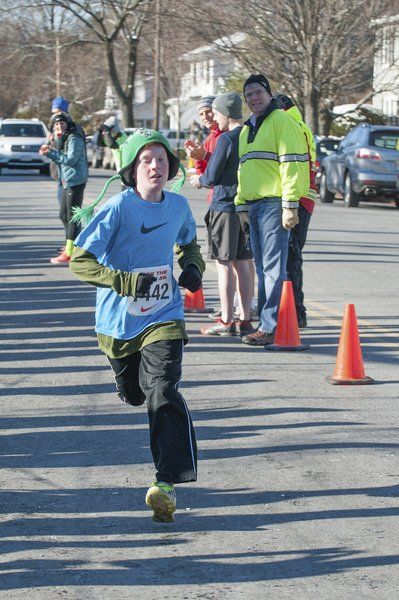 Nate May, 11, of Marblehead heads to the finish line placing first in the kids 1-mile run outside the Marblehead Community Center.