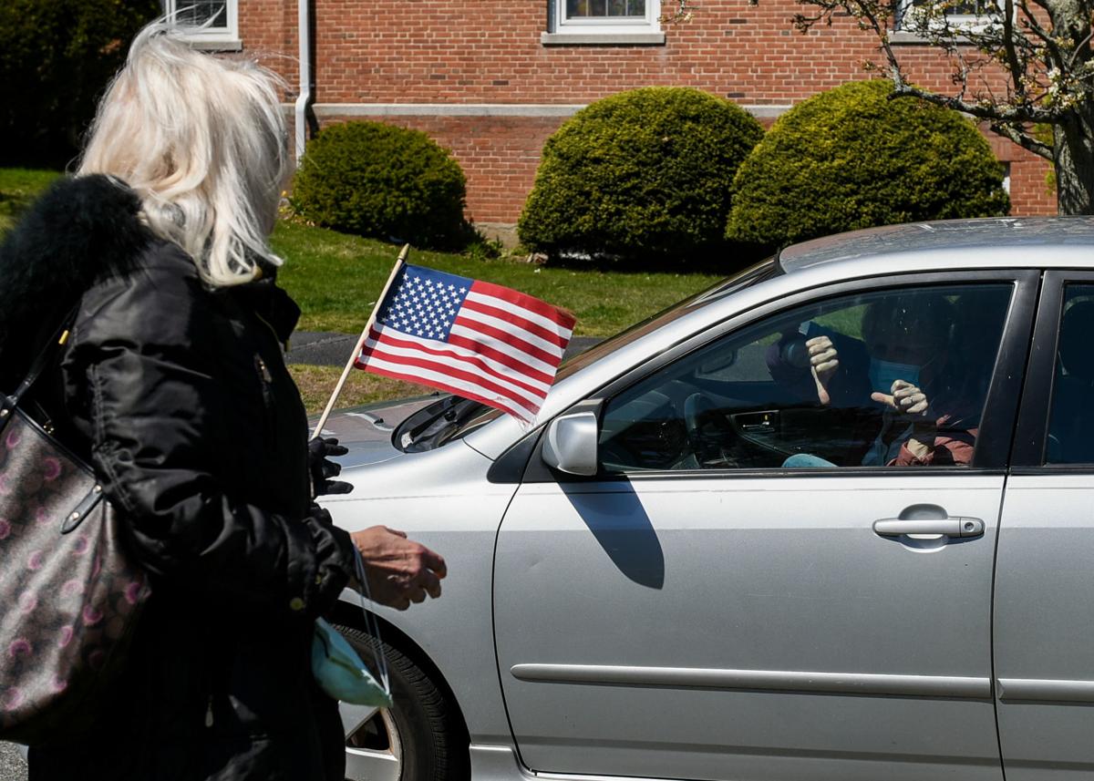 Protesters gather outside Gov. Charlie Baker's home in Swampscott