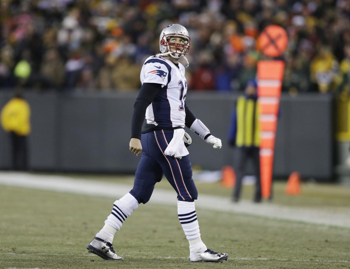 New England Patriots' Tom Brady looks back as he walks off the field during the second half.