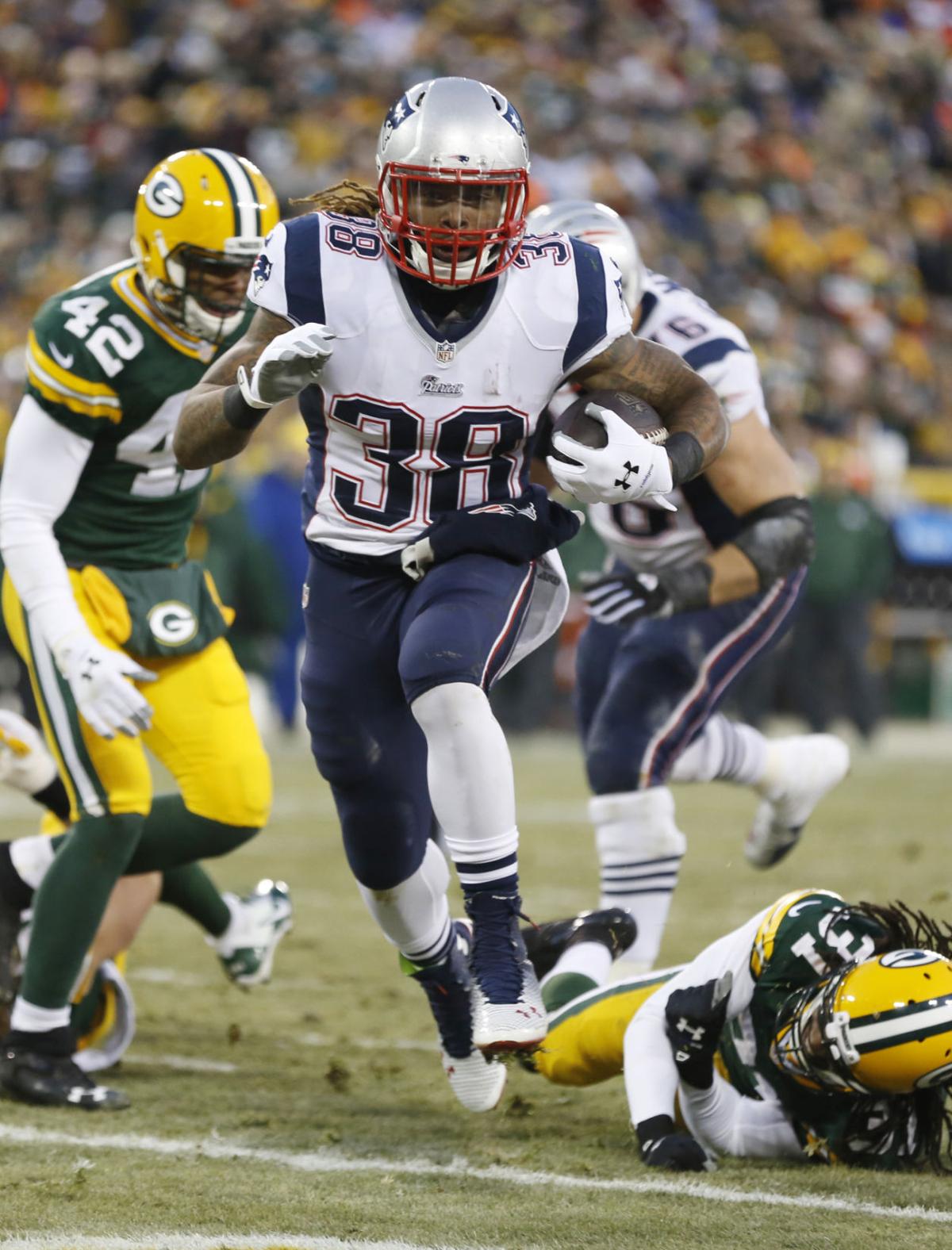 New England Patriots' Brandon Bolden runs for a touchdown during the first half.