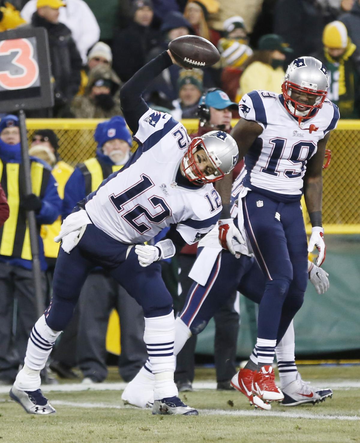 New England Patriots' Tom Brady spikes the ball after throwing a touchdown pass to Brandon LaFell (19) during the first half.