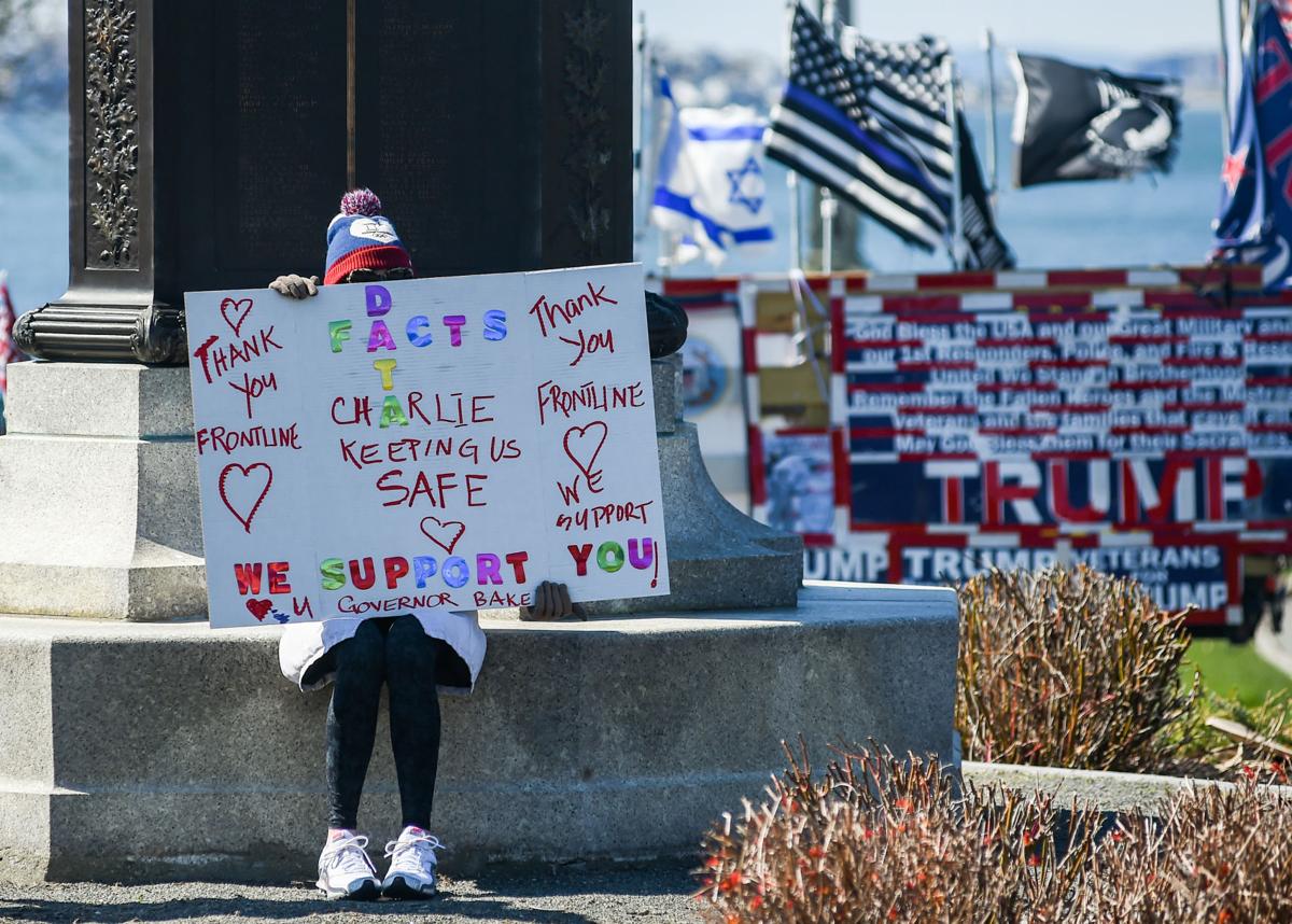 Protesters gather outside Gov. Charlie Baker's home in Swampscott