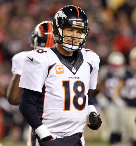 Denver Broncos quarterback Peyton Manning (18) unhappily leaves