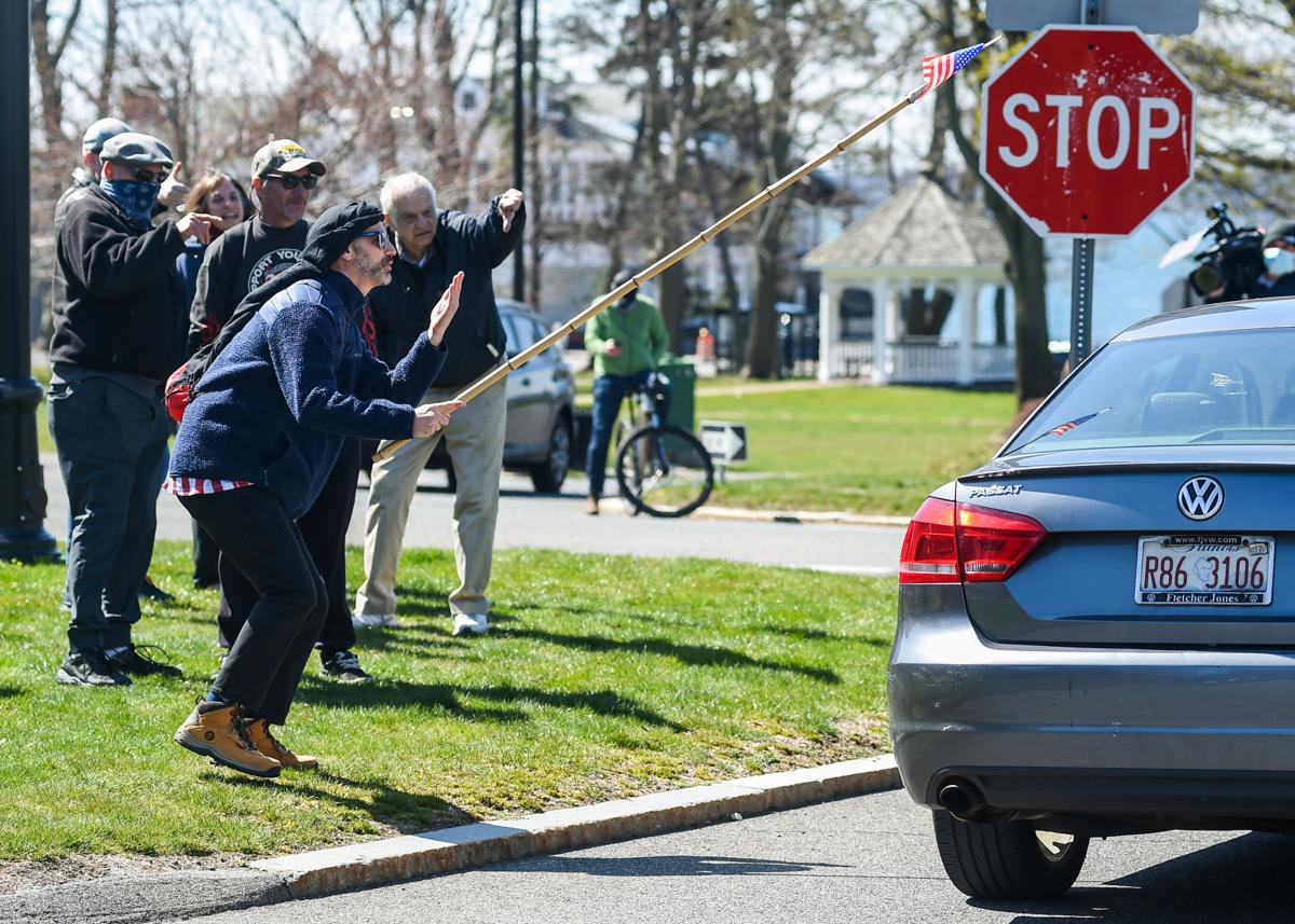 Protesters gather outside Gov. Charlie Baker's home in Swampscott