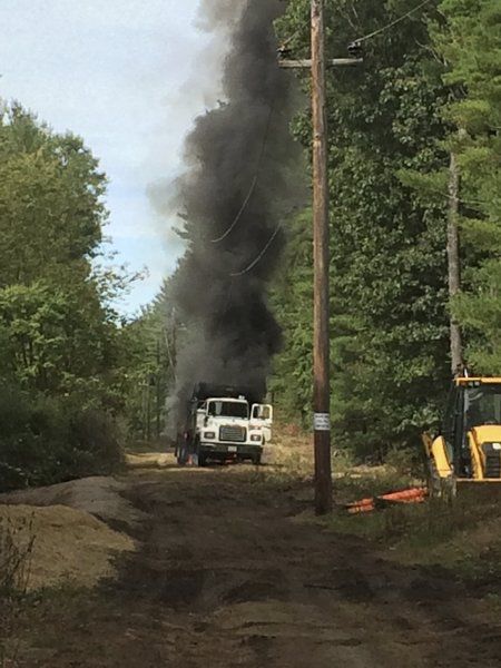 Dump truck backs into pole causing fire power outage Local