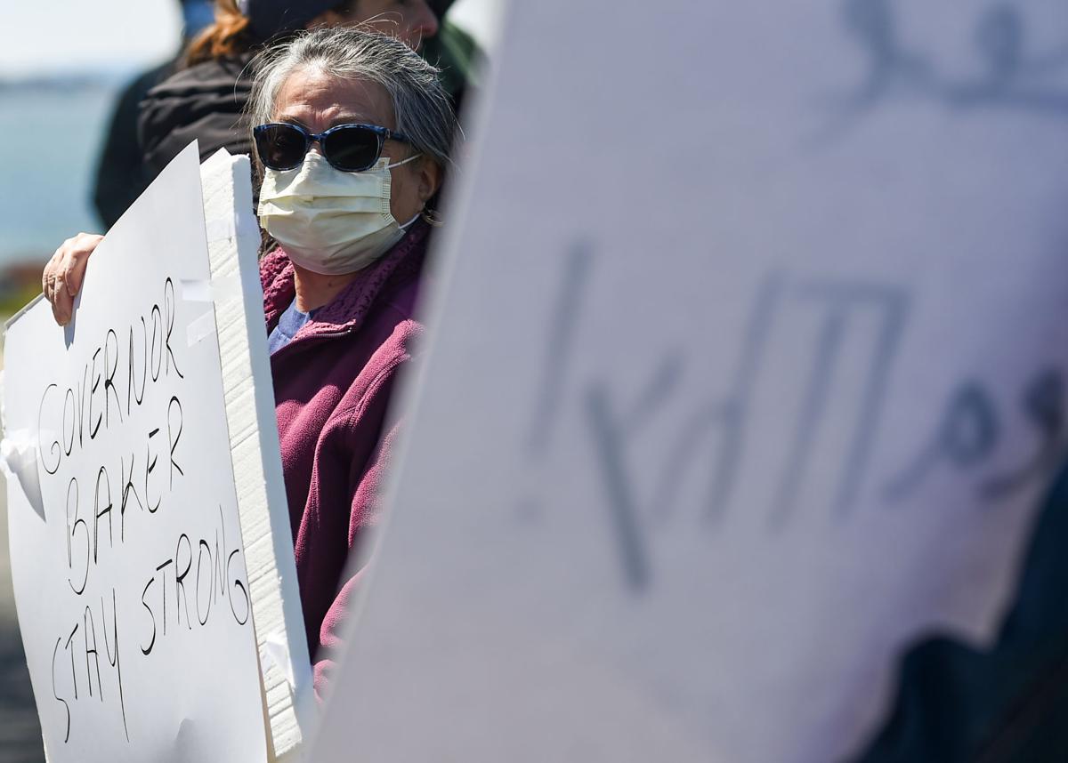 Protesters gather outside Gov. Charlie Baker's home in Swampscott