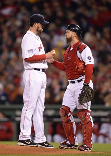 Boston Red Sox catcher David Ross (R) talks to pitcher John Lackey