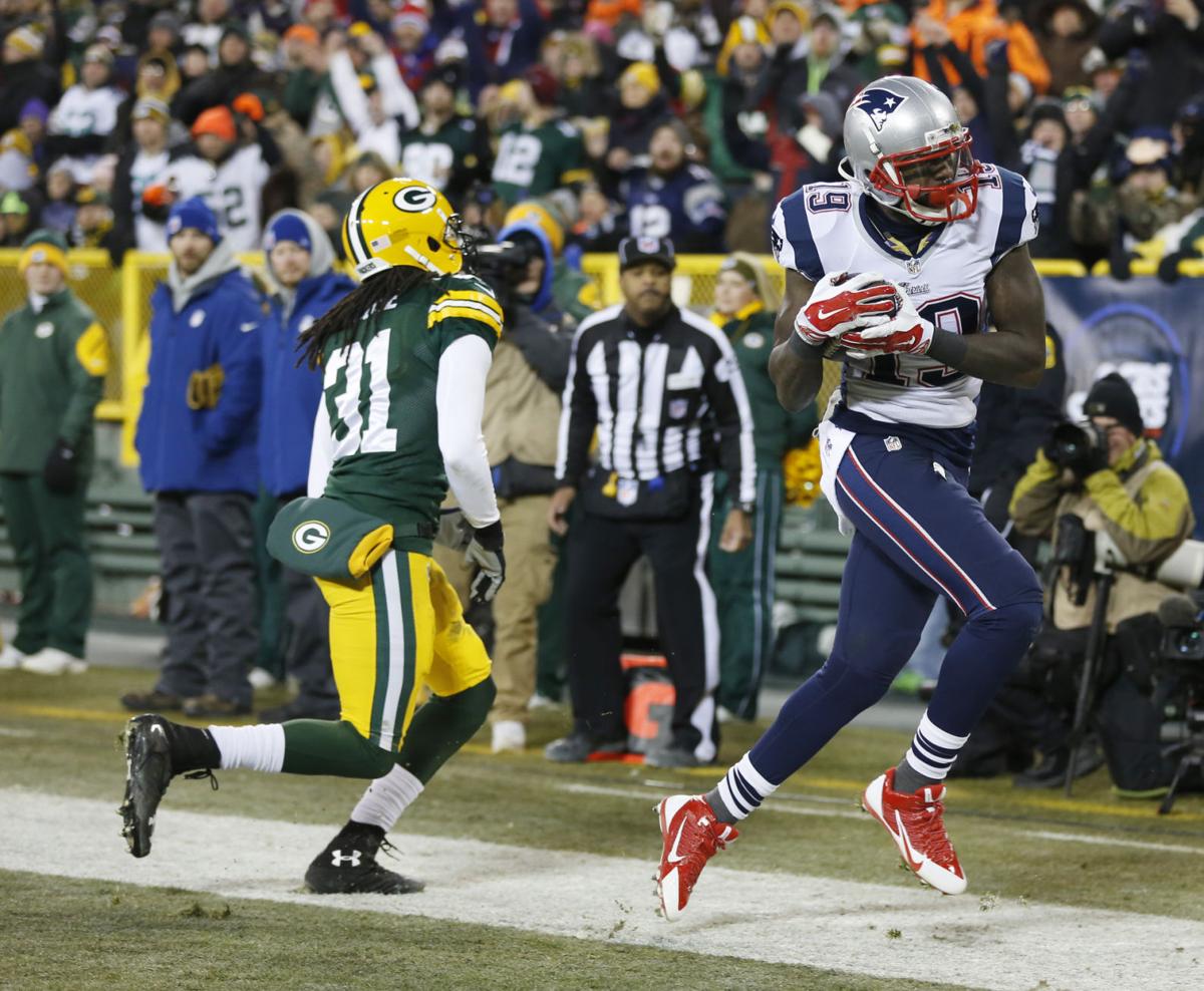 New England Patriots' Brandon LaFell catches a touchdown pass in front of Green Bay Packers' Davon House (31) during the second half.