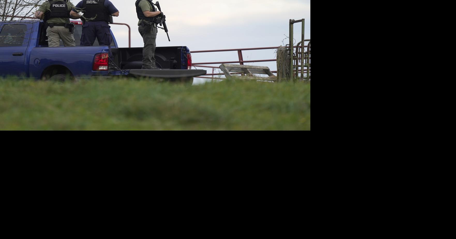 Heavily armed police surround home in search for suspect in the fatal ...