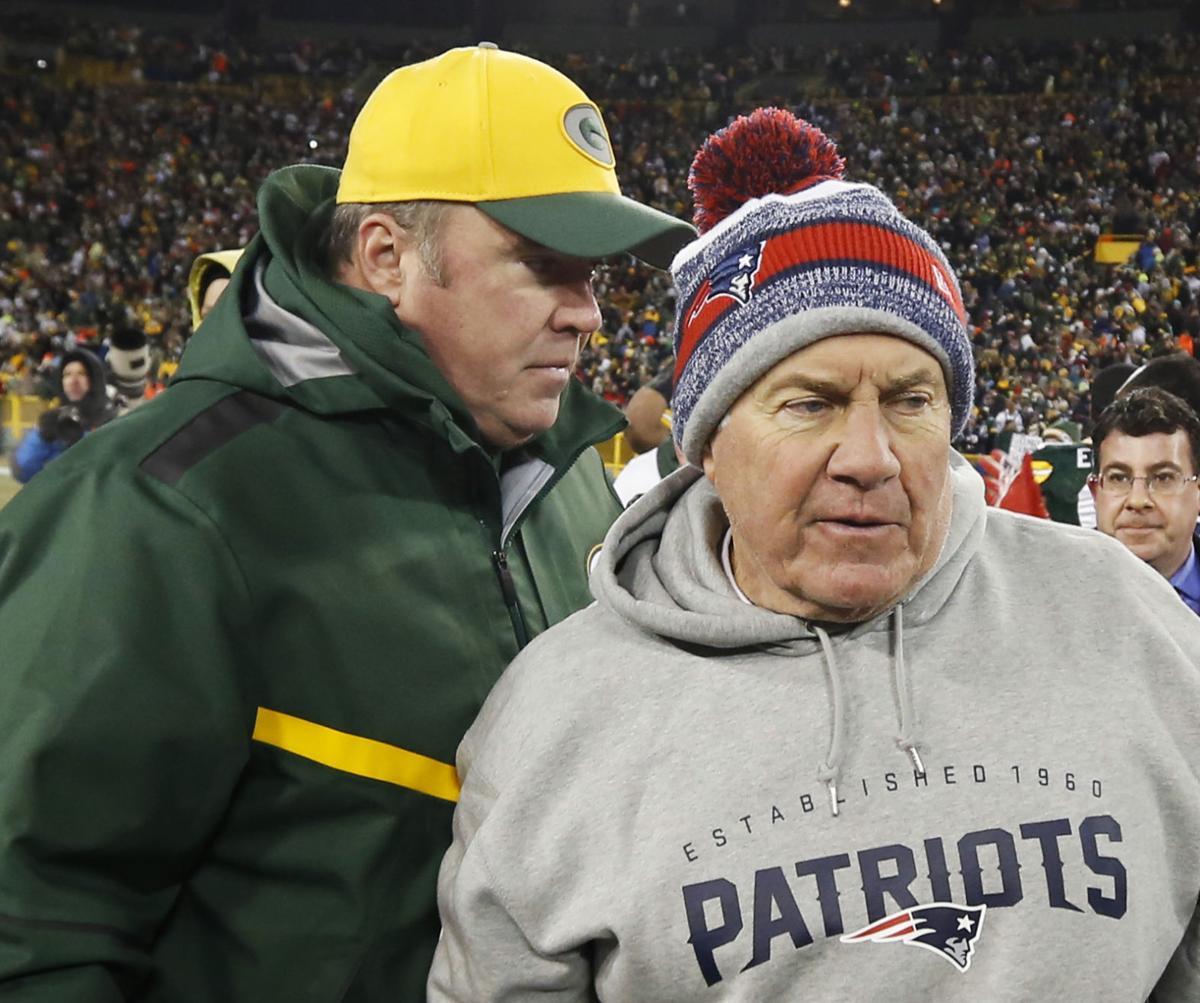 Green Bay Packers head coach Mike McCarthy talks to New England Patriots head coach Bill Belichick after the game.