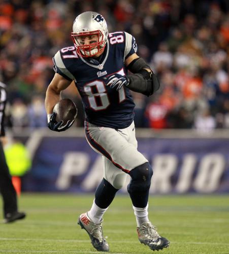 New England Patriots tight end Rob Gronkowski (87) finds open running room  against the Broncos on Sunday evening