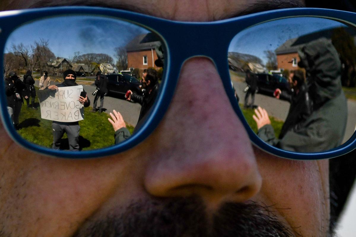 Protesters gather outside Gov. Charlie Baker's home in Swampscott