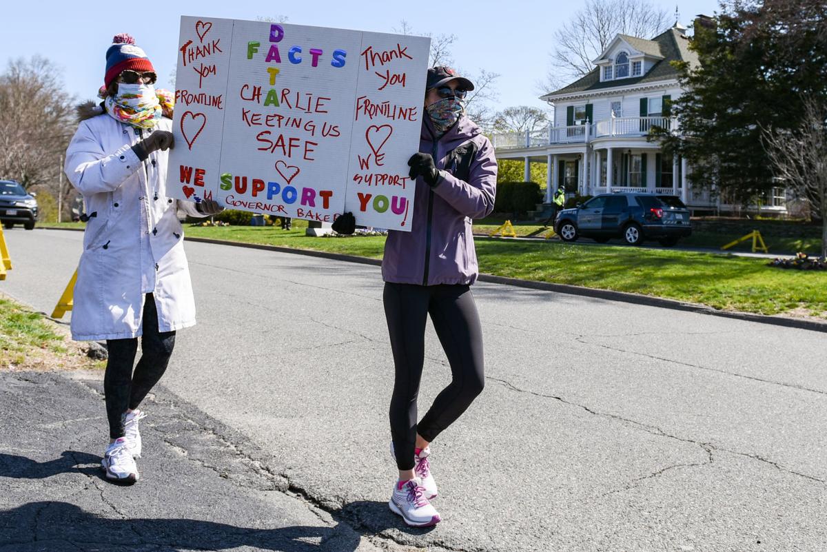Protesters gather outside Gov. Charlie Baker's home in Swampscott