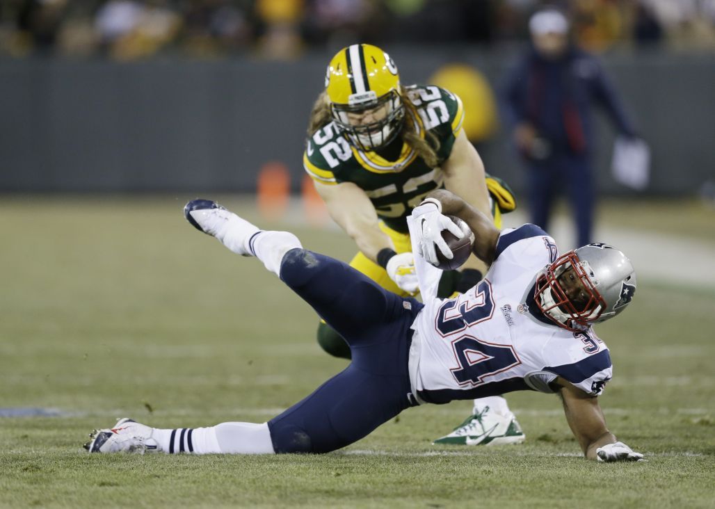 Green Bay Packers' Clay Matthews tackles New England Patriots' Shane Vereen during the first half.