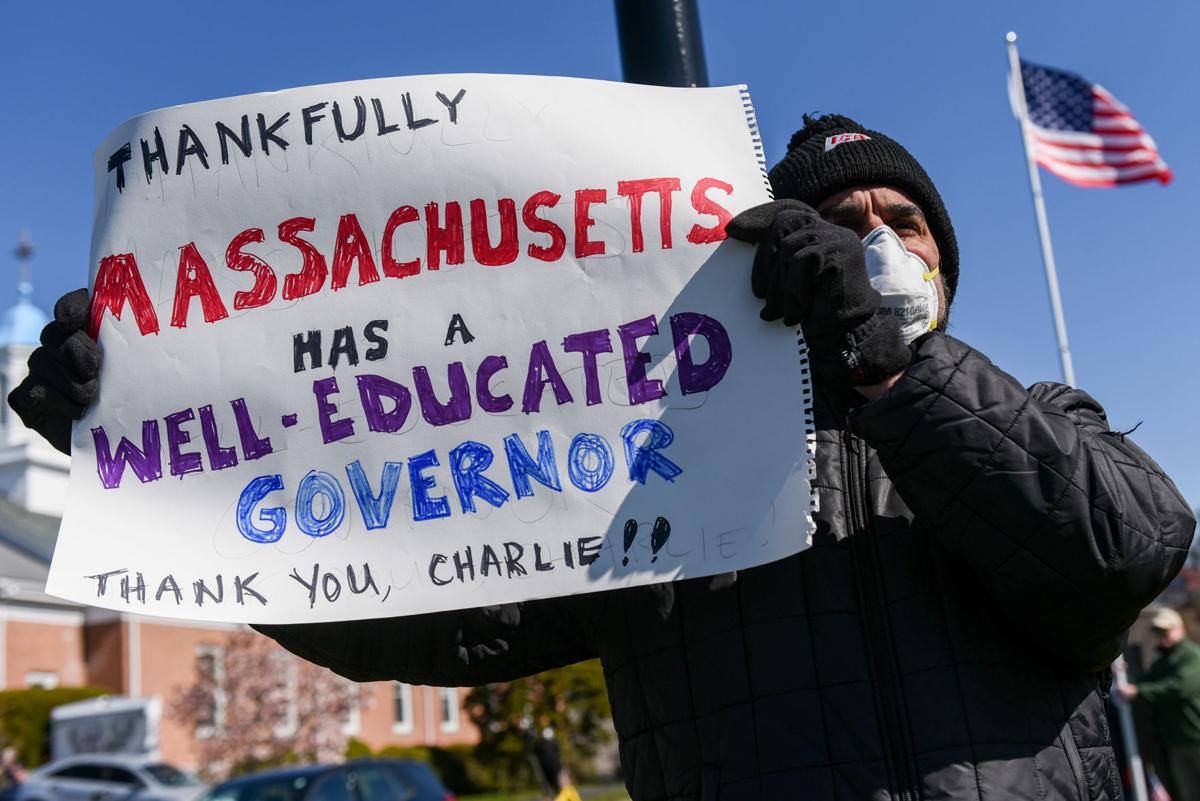 Protesters gather outside Gov. Charlie Baker's home in Swampscott