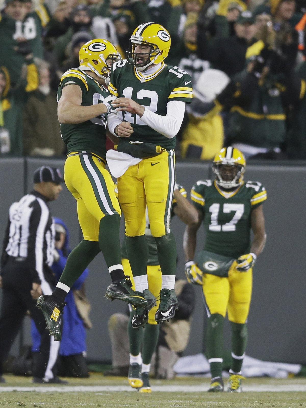 Green Bay Packers quarterback Aaron Rodgers celebrates with Jordy Nelson (87) after a 45-yard touchdown pass.
