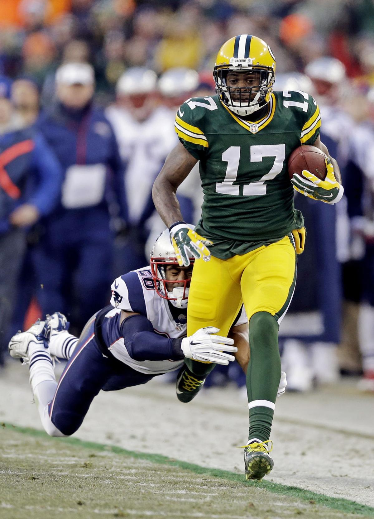 Green Bay Packers' Davante Adams tries to break away from New England Patriots' Logan Ryan during the first half.