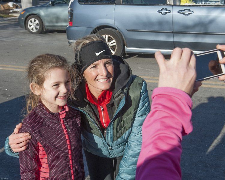 Lily Comander 7, of Newton, gets her photo taken by her mom Amy, with Marblehead native and three-time Olympian Shalane Flanagan.