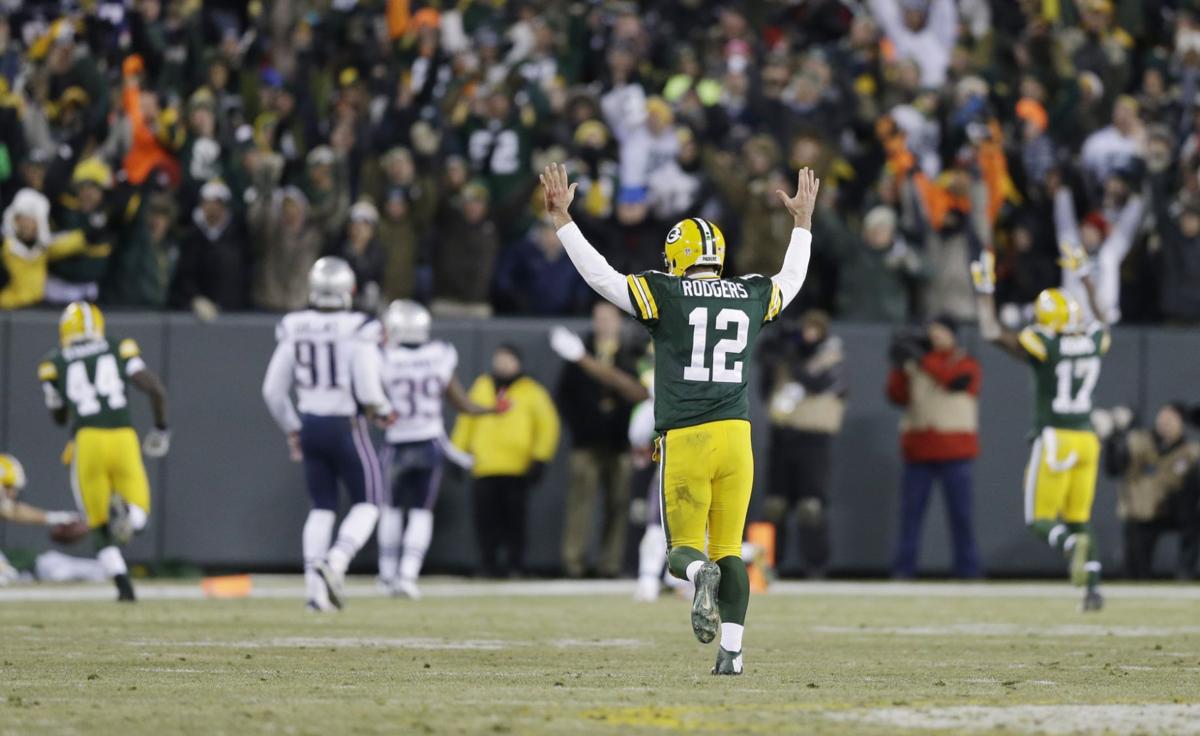 Green Bay Packers quarterback Aaron Rodgers celebrates a 45-yard touchdown pass to Jordy Nelson during the first half.