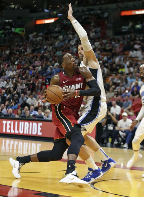 The Miami Heat's Bam Adebayo (13) drives against the Orlando Magic's Nikola Vucevic (9) in the second quarter at the AmericanAirlines Arena in Miami on Wednesday, March 4, 2020.
