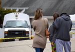 Local community members wait for developments in front of Ruben Flores's house in Arroyo Grande and San Luis Obispo Sheriff personnel search the backyard.