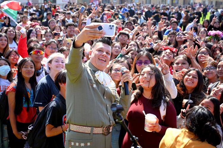 Josue Hernandez "El Charro de America" takes a selfie with hundreds on Santa Maria High School students during the fall fair lunch time event Friday.