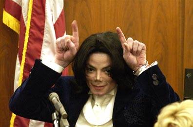 Michael Jackson gestures to a still photographer Dec.3 in Santa Maria Superior Court during a ,21 million lawsuit brought against him by Marcel Avram for failing to appear at two millennium concerts that were to take place Dec 31, 1999. This particular ...